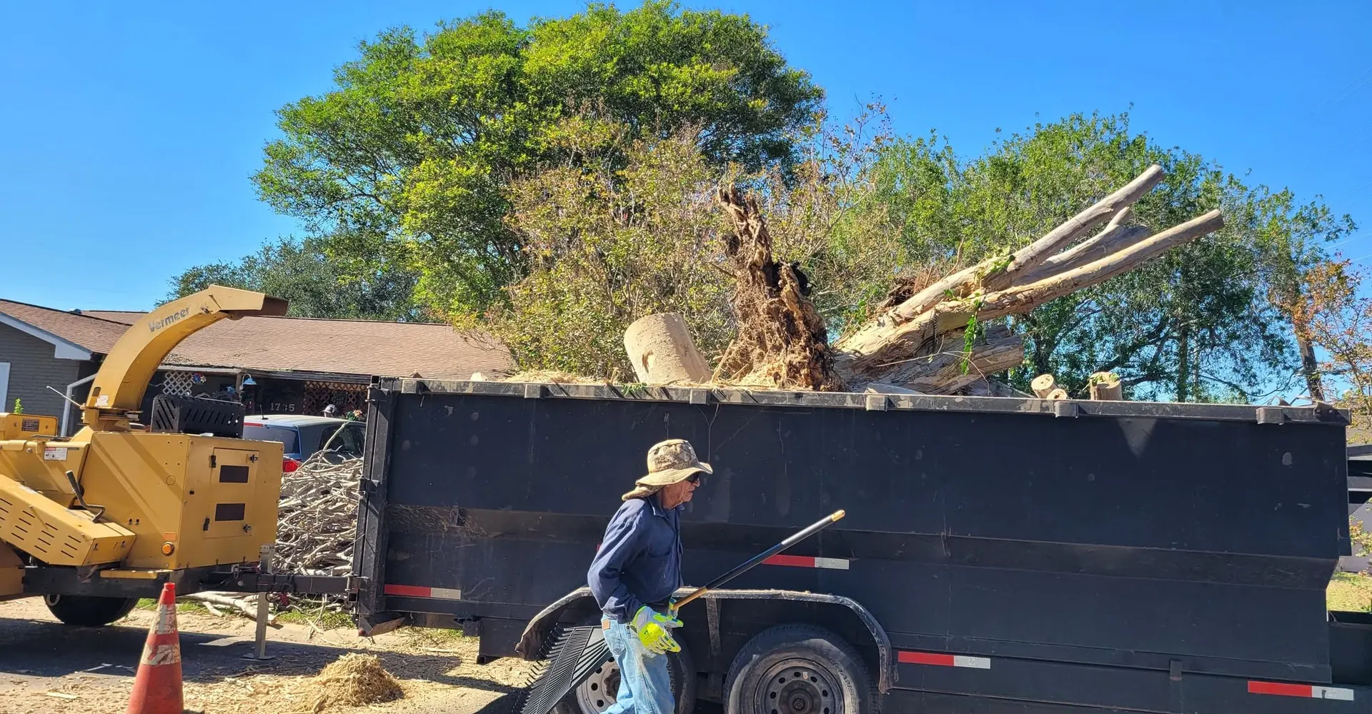 Crew loading brush into the dump trailer